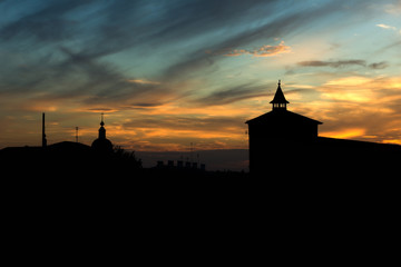 silhouette of old town and fortress tower at sunset