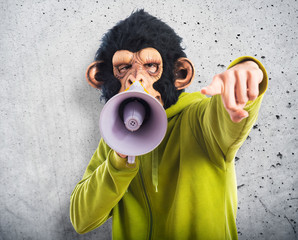 Fototapeta premium Monkey man shouting by megaphone