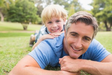 Fototapeta premium Happy father and his son smiling at camera