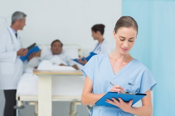 Doctor with colleague and patient behind