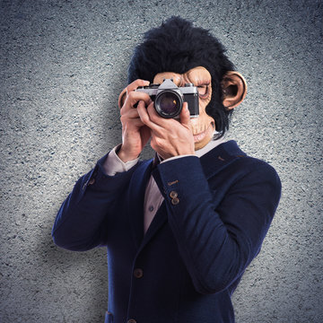 Monkey man photographing over white background