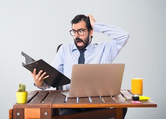 Frustrated businessman in his office with his folder