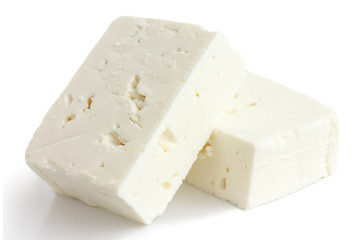 Greek feta cheese block isolated on white. - obrazy, fototapety, plakaty
