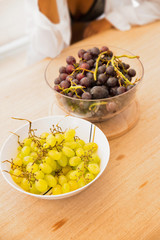 Serving size of fresh fruit on picnic table/Grapes in a bowl on picnic table