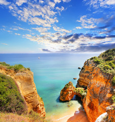 Rocky beach at sunset, Lagos, Portugal. Travel and business background