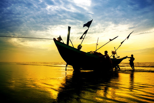 Fishermen Fishing In The Sea At Sunrise In Namdinh, Vietnam.