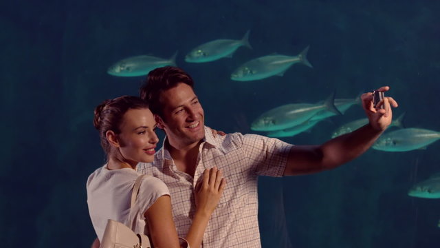  Happy couple taking a selfie at the aquarium