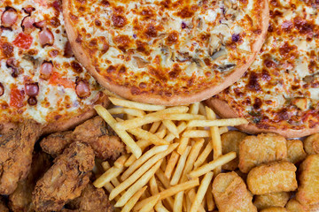 fastfood chicken nuggets, legs, pizzas and fry potatos