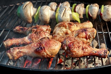 BBQ Chicken Legs And Mushrooms On The Hot Charcoal Grill