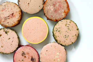 A variety of round pates on plate. From above.