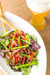 plate of salad from meat with vegetables and light bear
