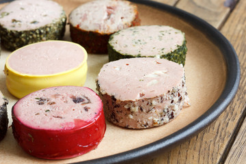 A variety of round pates on rustic plate. Detail.