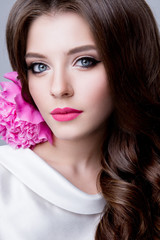 Fototapeta na wymiar Close-up studio portrait of beautiful woman with bright make-up