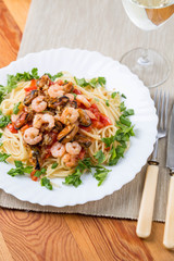pasta with seafoods and white wine on napkin