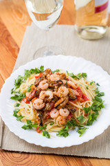 pasta with seafoods and white wine on napkin