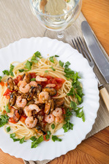 pasta with seafoods and white wine on napkin