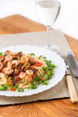 pasta with seafoods and white wine on napkin