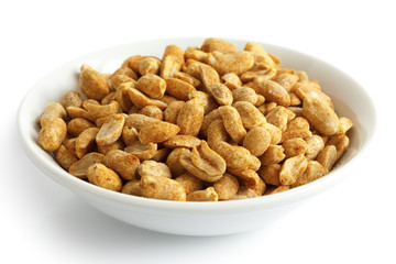 Spicy dry roasted peanuts in white bowl. Isolated.