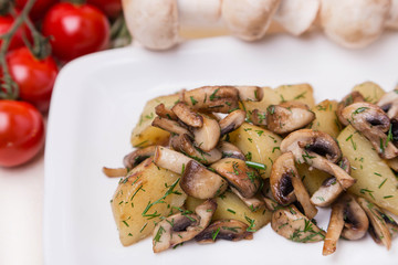 hot potato and mushroom with garnish on white plate