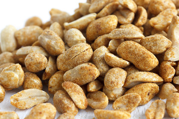 Fototapeta na wymiar Spicy dry roasted peanuts detail in perspective.