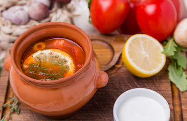 soup saltwort with garnish in brown ceramic pot