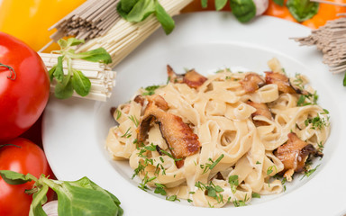 noodles with vegetables and garnish on white plate