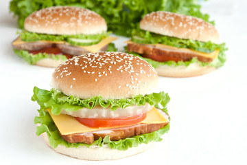 three burger with meat and vegetables