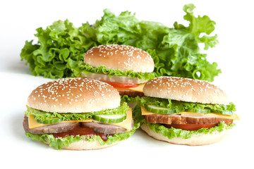 three burger with meat and vegetables