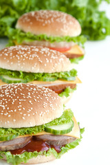 three burger with meat and vegetables