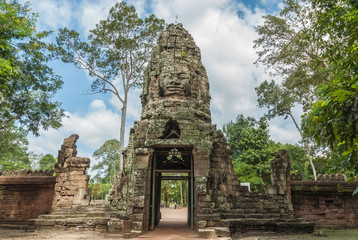 sight of the gopura of entry with the lokeshvara face to the archaeological ta prohm place in siam...