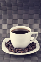 Cup of coffee with coffee beans