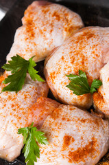 raw chicken with spice on frying pan