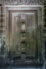 blind door with bas-reliefs of the prasat of the temple thommanon in siam reap, cambodia