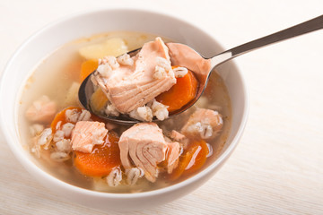 fish soup with salmon and orge perlé in spoon