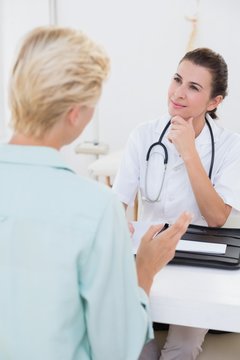 Smiling doctor speaking with her patient 