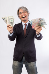 Happy business man hold China , hongkong , united state of america, korea and japan money over a white background, asian model