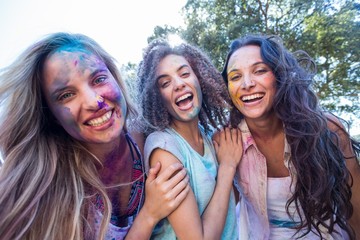 Happy friends covered in powder paint