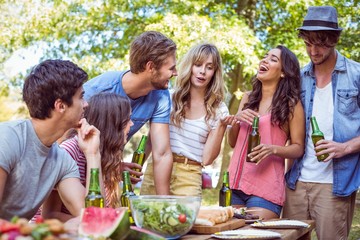 Happy friends in the park having lunch