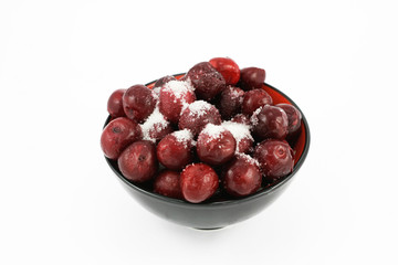 red cherry with sugar in black bowl
