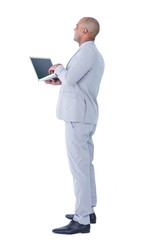 Naklejka na ściany i meble Businessman using his laptop computer 