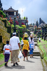 Balinese people walk in traditional dress in Pura Besakih