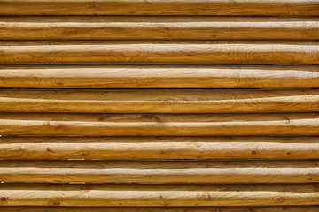 fence of stacked round trunks wood pattern