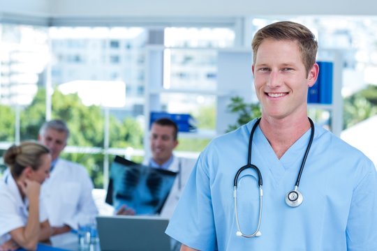 Handsome smiling doctor looking at camera 