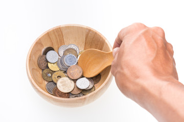Japan coin in wooden bowl on white background