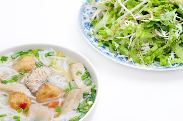 Bun cha ca or Vietnamese rice vermicelli with grilled fish and herbs on a white background