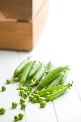 fresh green peas on kitchen table