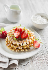 waffles with strawberries on a white plate