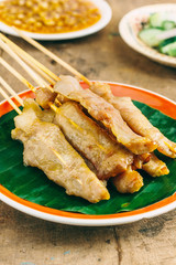 Pork Satay with delicious peanut sauce, one of famous local dishes.
