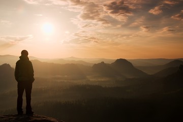 Girl tourist on the rock above valley in rocky mountains