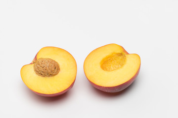 Nectarine - cut in half over white background